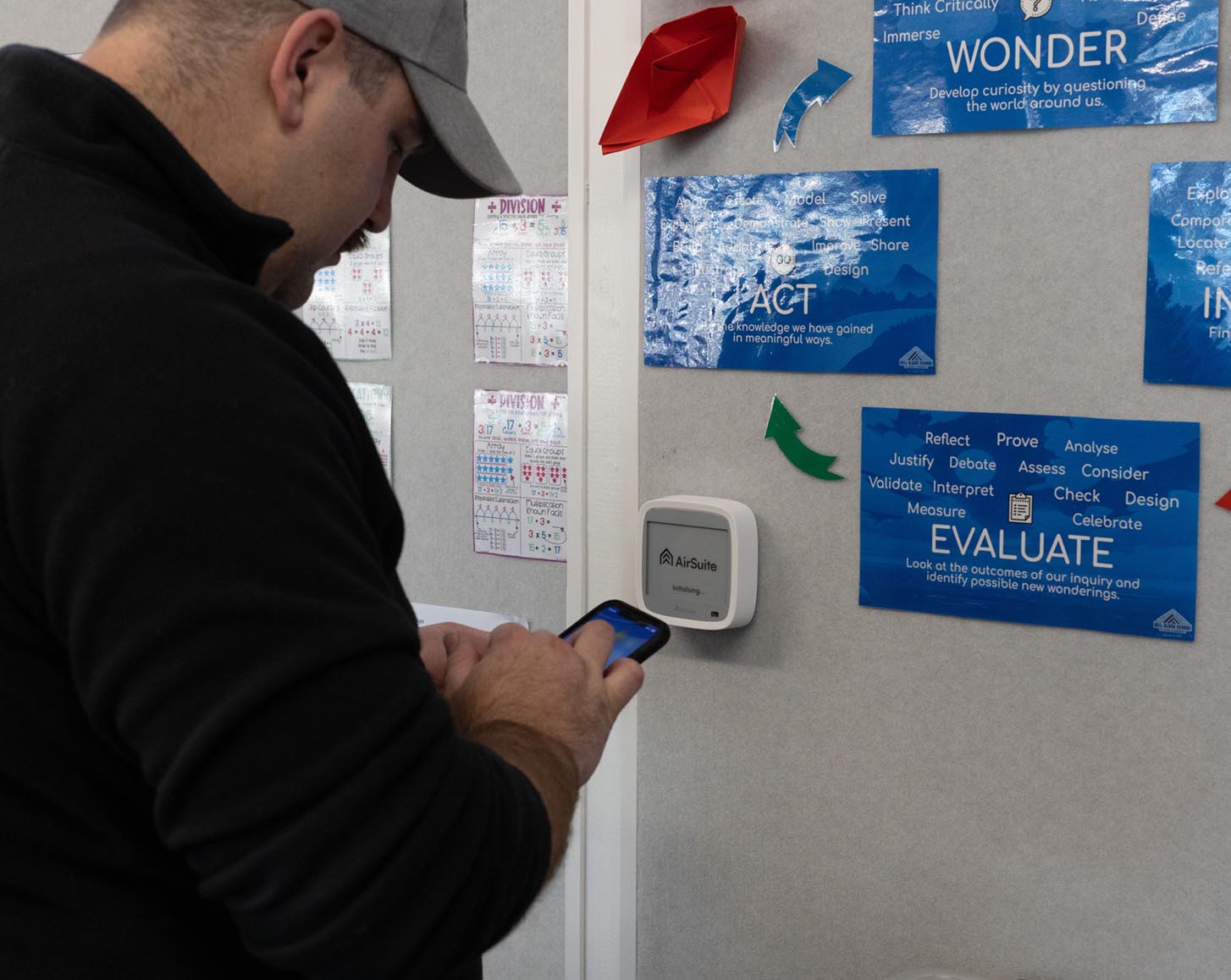 An installer uses the AirSuite app to finish installing an AirSuite sensor