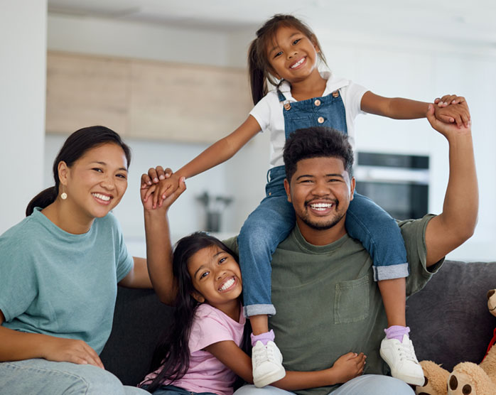 A happy New Zealand family on the couch at home