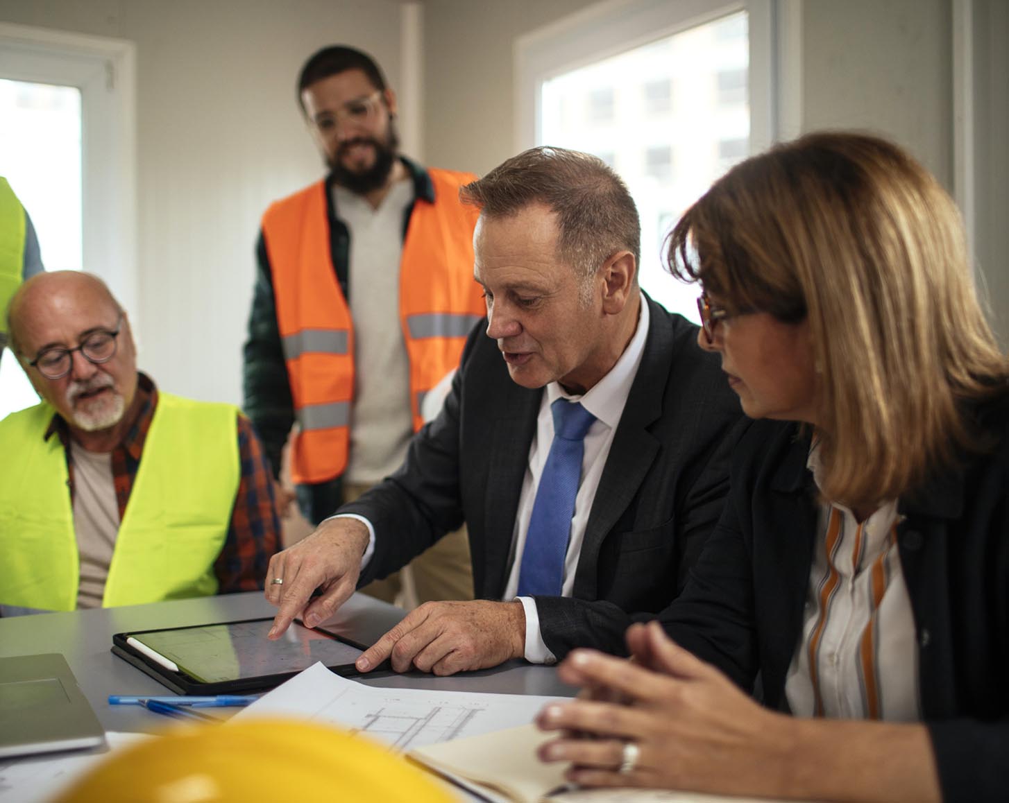 An executive points at a tablet
