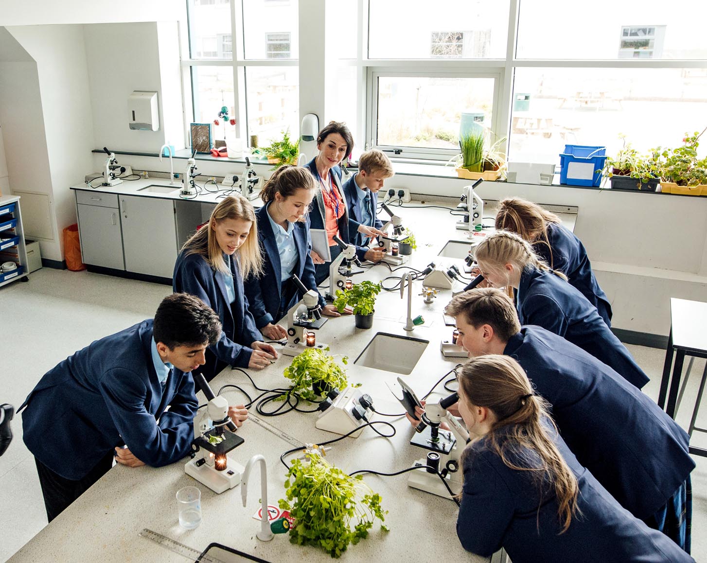 Students looking into microscopes in a science class