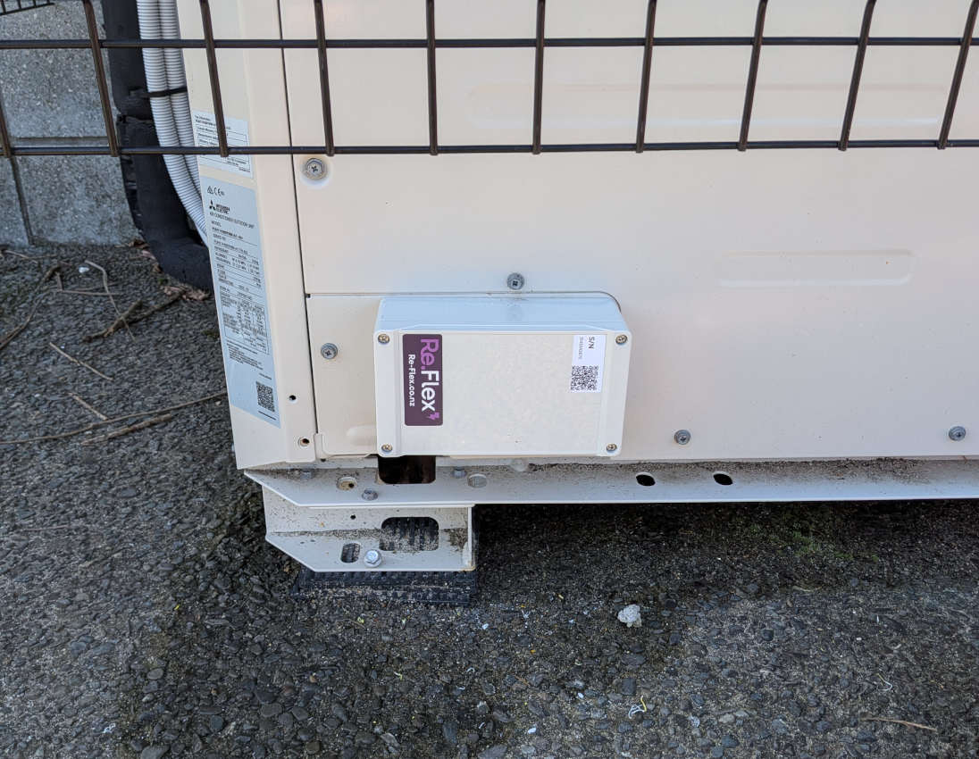 A small, rectangular Re.Flex Edge enclosure attached to the bottom-left of an outdoor HVAC unit