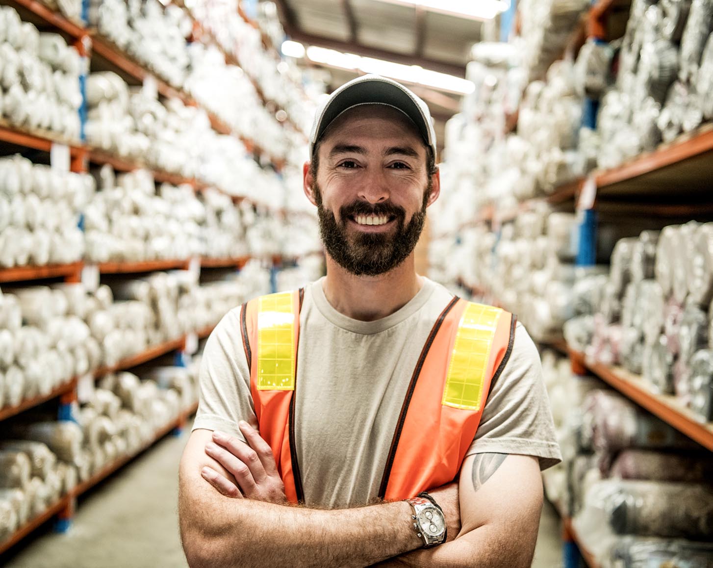 A person wearing a hi-vis vest in a warehouse